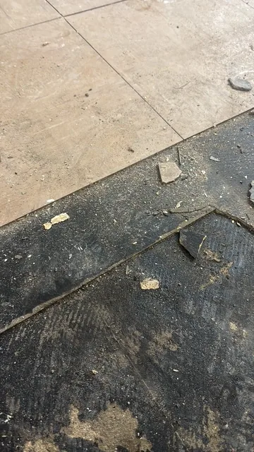 Black bitumen mastic floor removal in a NW1 flat